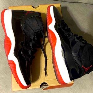Men red and black  Jordan 11’s , size 9.5